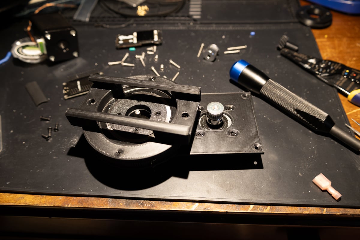 Mechanism assembly with magnetic arm and sand tray